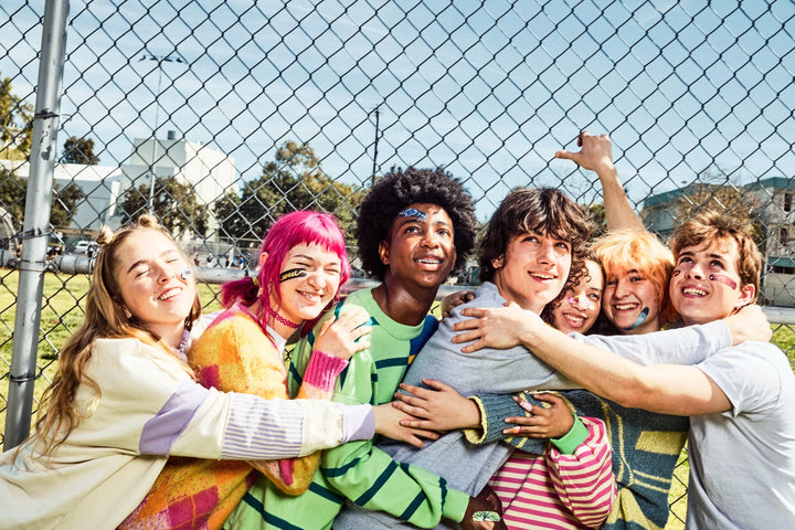 Group of teens hanging out together outdoors
